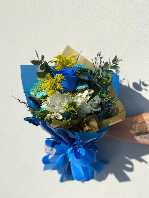 Buquê com flores tingidas de azul e flores brancas